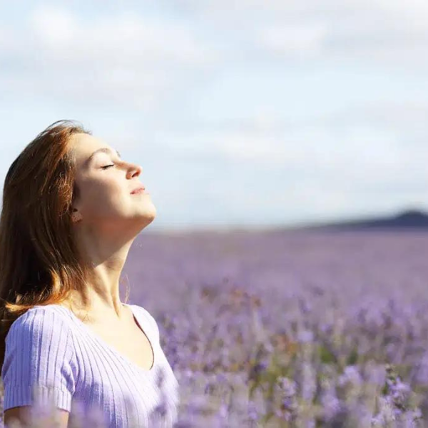 Happy women in the lavender field inhaling the fragrance